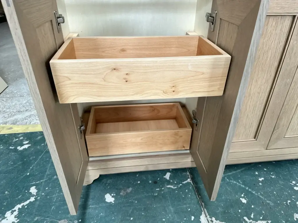 Close-up of 3/4-inch furniture-grade plywood kitchen island base cabinets with reinforced corner blocks.