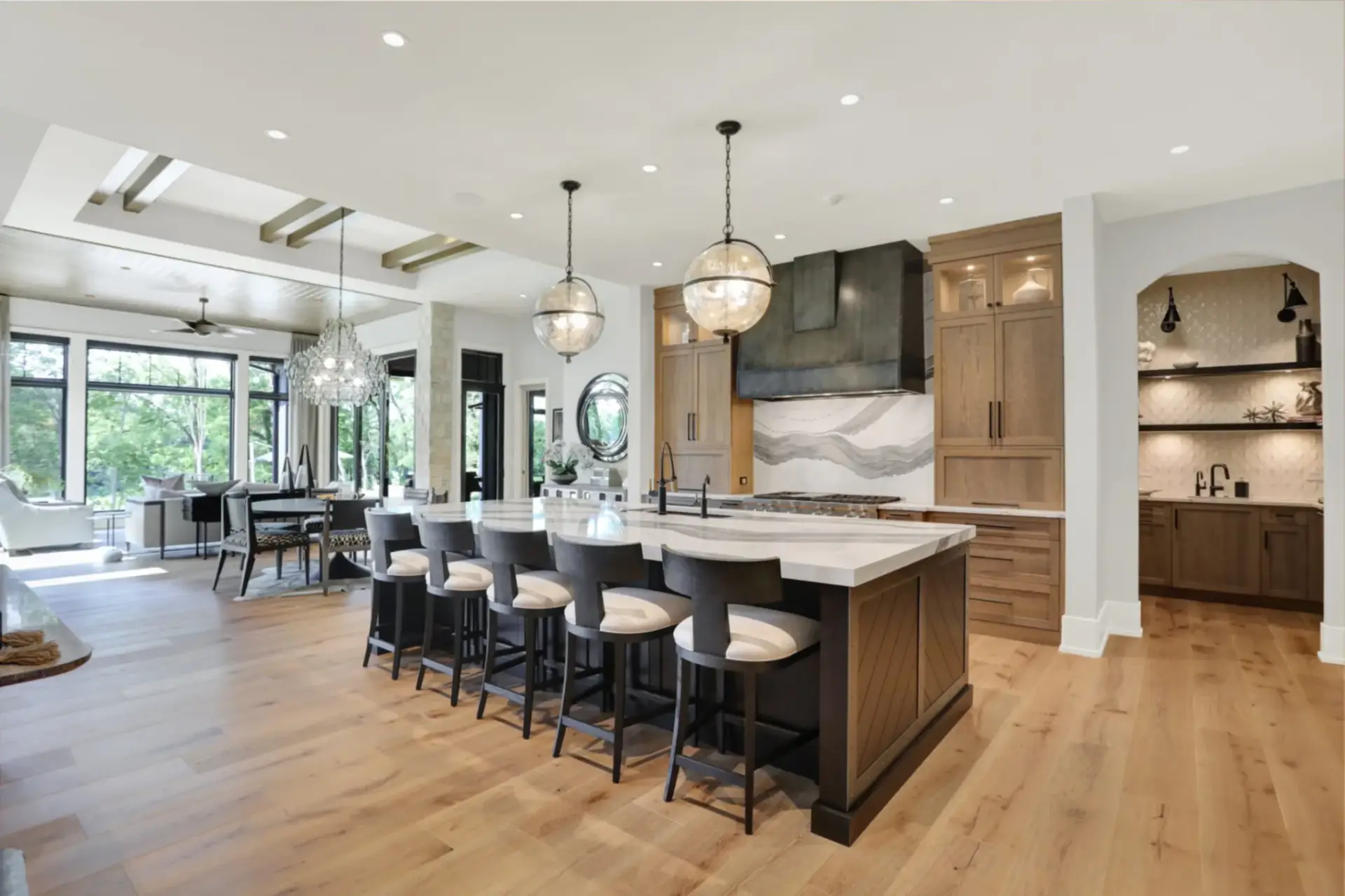 Walk-in butler pantry featuring rift sawn white oak storage cabinets, open shelving, a built-in Miele coffee maker, and a prep sink.