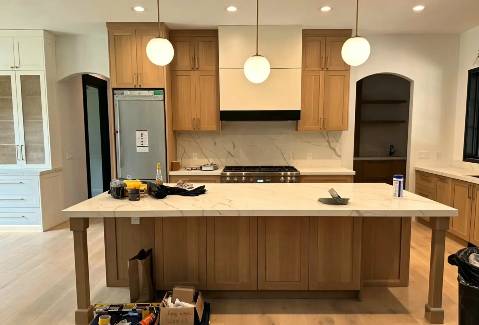 Custom kitchen island with seating featuring a 15-inch countertop overhang and integrated steel support brackets.