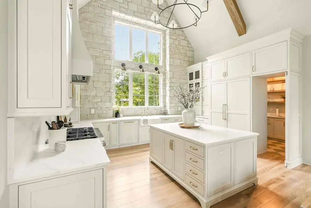 Full-height appliance storage tower showcasing built-in refrigeration panels and integrated soft close kitchen cabinets doors with brass pulls.