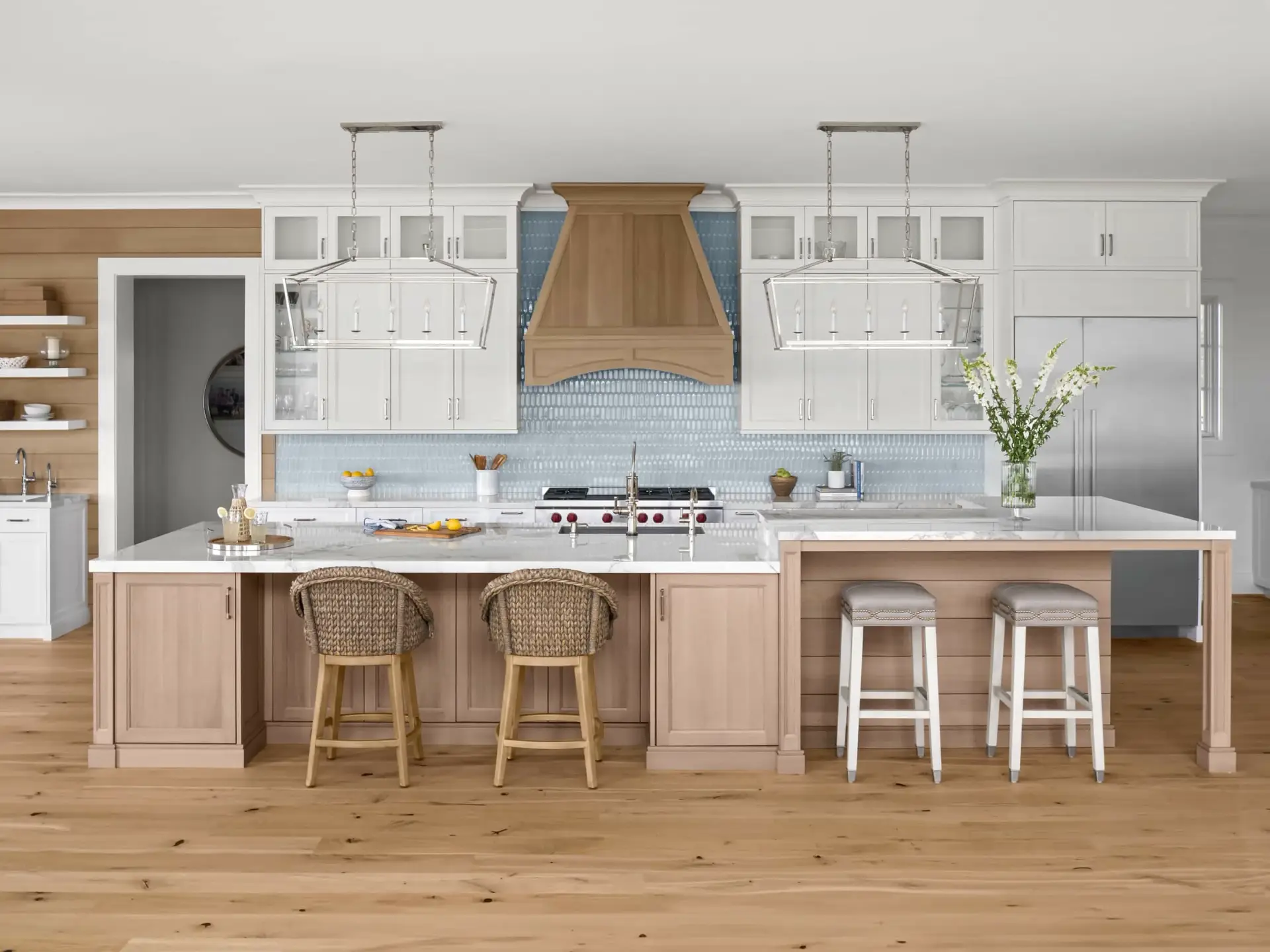 Symmetrical front elevation showcasing contemporary coastal kitchen designs featuring full-overlay cabinetry and bright pendant lights.