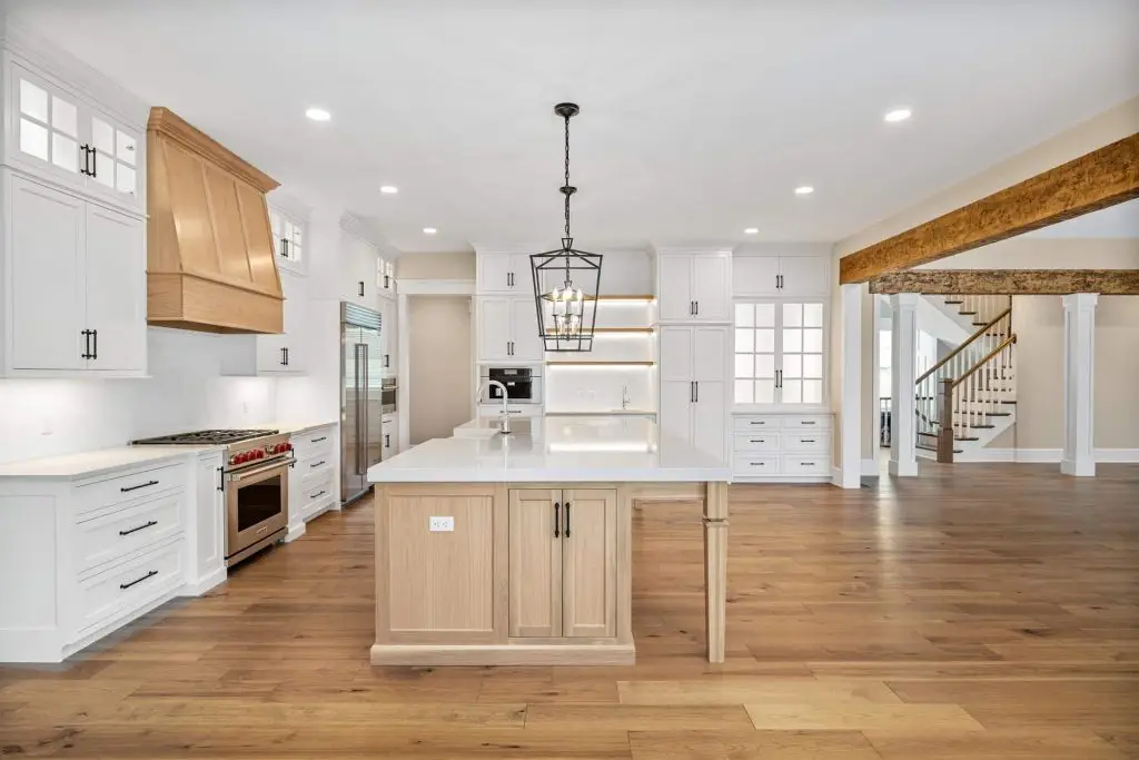 Broad landscape view showcasing inspiring white kitchen ideas seamlessly transitioning into a spacious, light-filled great room area.