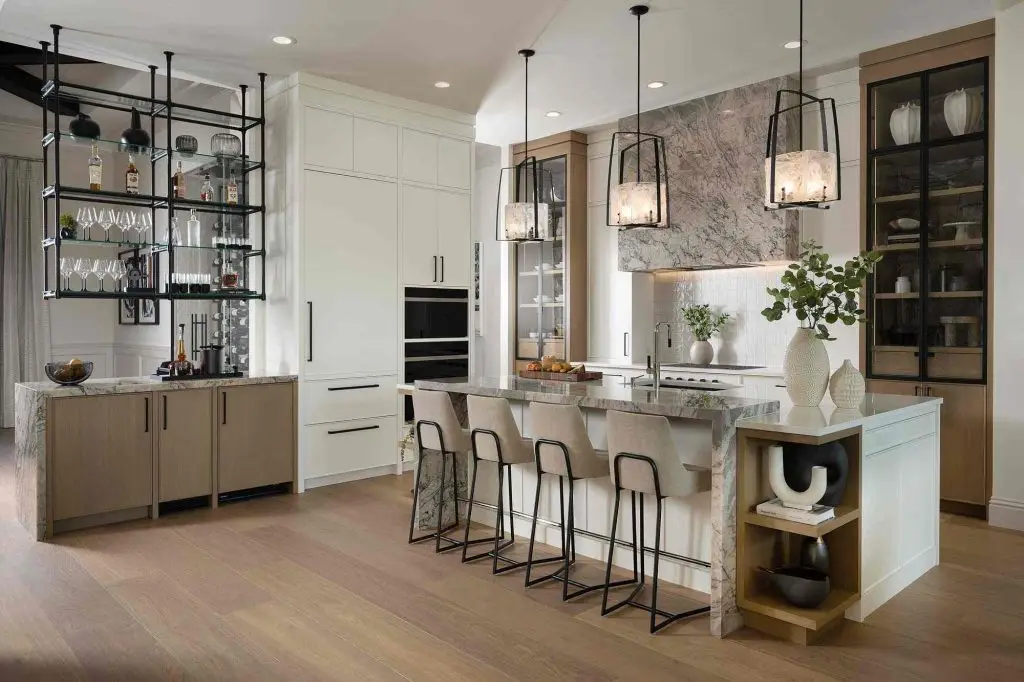 Wide multi-zone landscape view of a luxury slim shaker kitchen configuration featuring tall built-in columns and integrated light oak flooring.