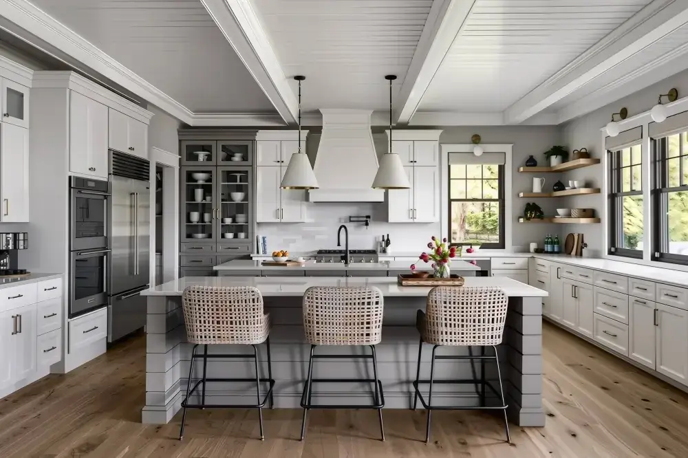 Comprehensive view of an open-concept layout featuring premium white and grey kitchen cupboards and dual white light fixtures.