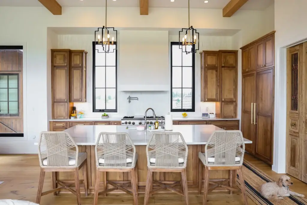 Elevation view of custom alder cabinets kitchen surrounding a white plaster hood and gas cooktop.