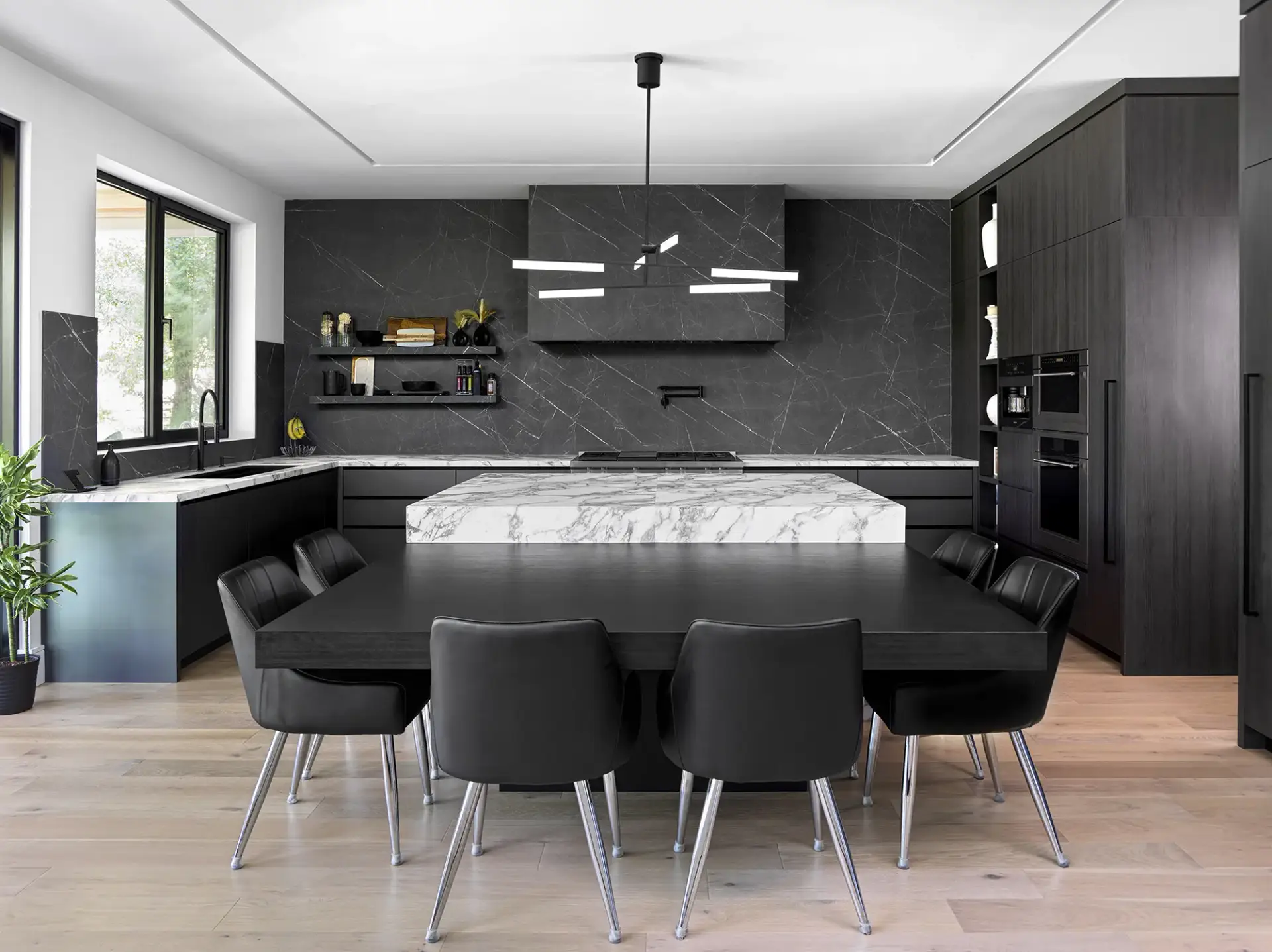 Luxury great room perspective showcasing a high-capacity black cabinets kitchen array with an integrated black oak dining suite.