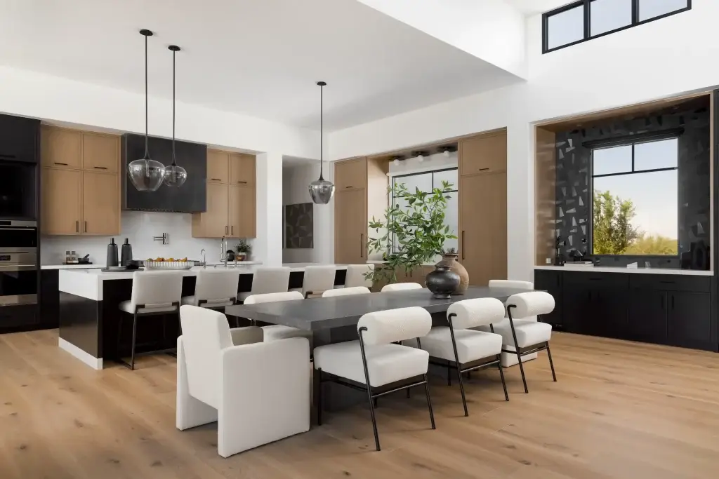 Direct elevation view of black kitchen vent hoods shroud flanked by rift white oak wall cabinets.