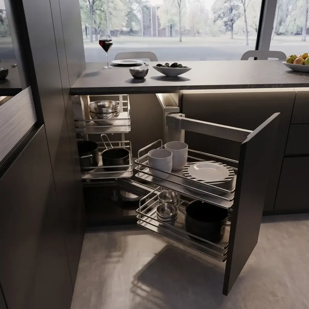 Close-up architectural detail of an open blind corner base cabinet featuring a two-stage magic corner pull-out basket mechanism in matte anthracite finish.