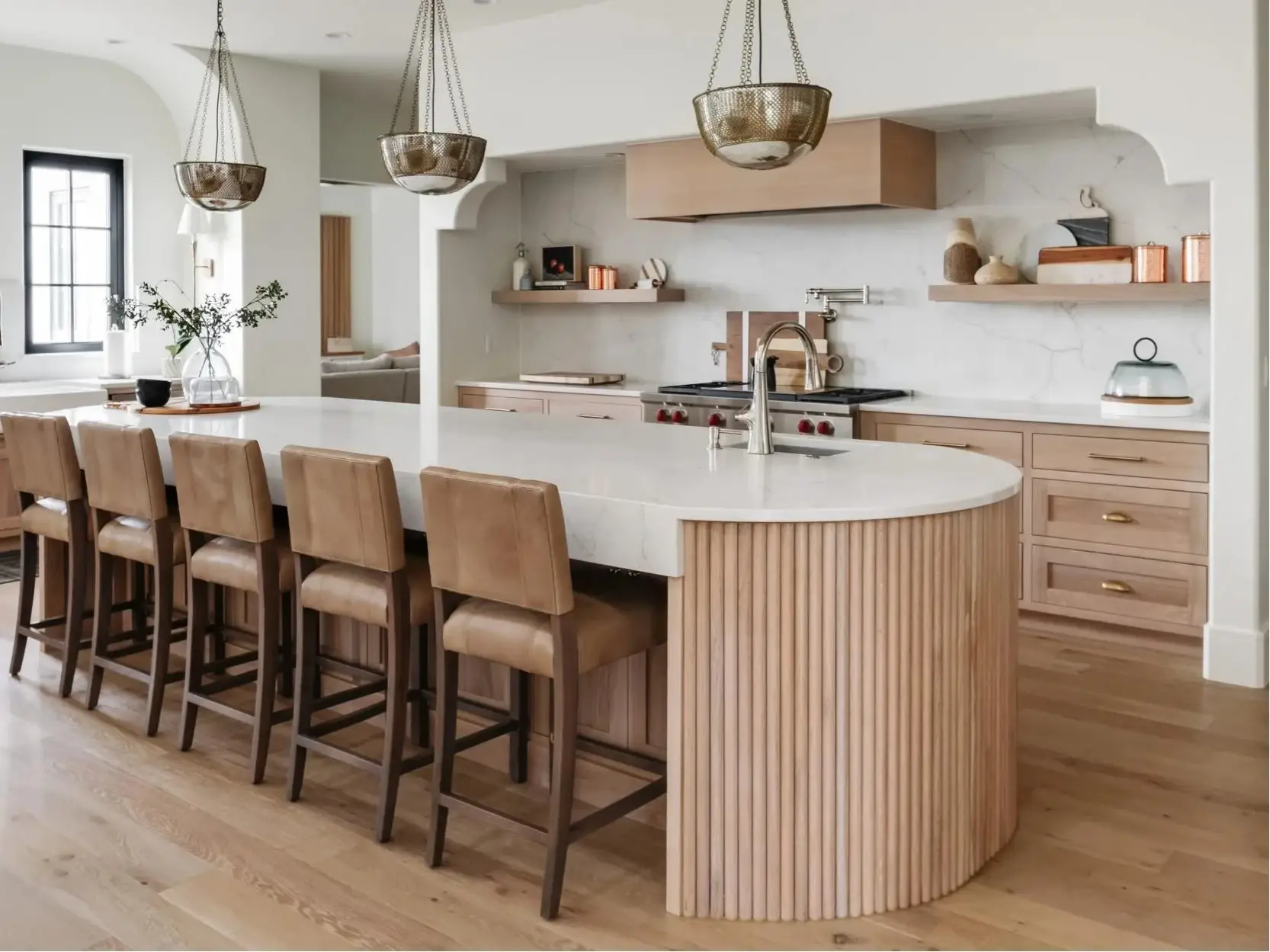 Exquisite modern curved kitchen island featuring a custom futed wood base and rounded premium countertop edge detailing.