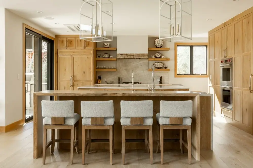 Side perspective tracking custom modern rustic kitchen base cabinets flanking an under-mount cleanup sink station.