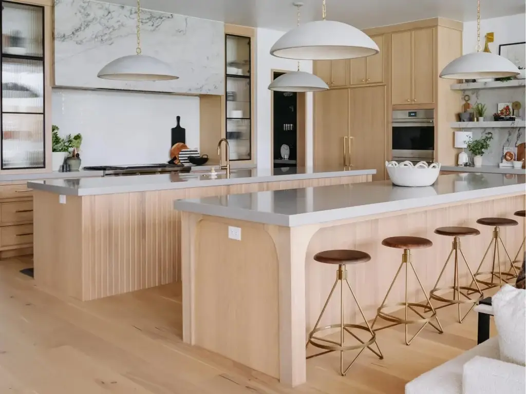 Malestic custom kitchen with 2 islands separating the primary cooking prep station from the outer quartz-topped entertainment bar.
