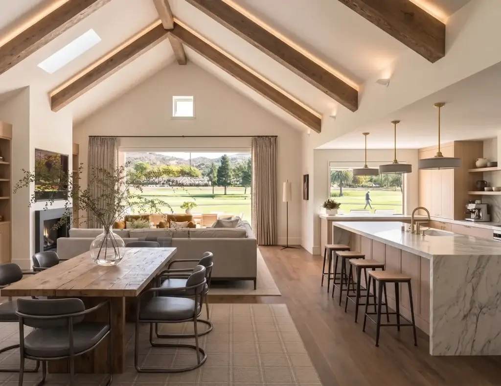 Luxury open concept vaulted ceiling kitchen featuring double-stacked custom cabinets scribed precisely to the sloped ceiling.