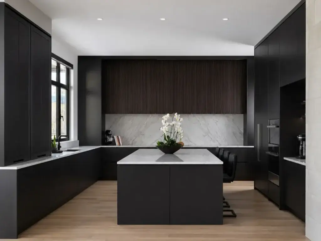 Expansive modern luxury u shaped kitchen layout with island featuring 42-inch perimeter clearances, mitered quartz countertops, white oak cabinetry, and brass pendant lighting.
