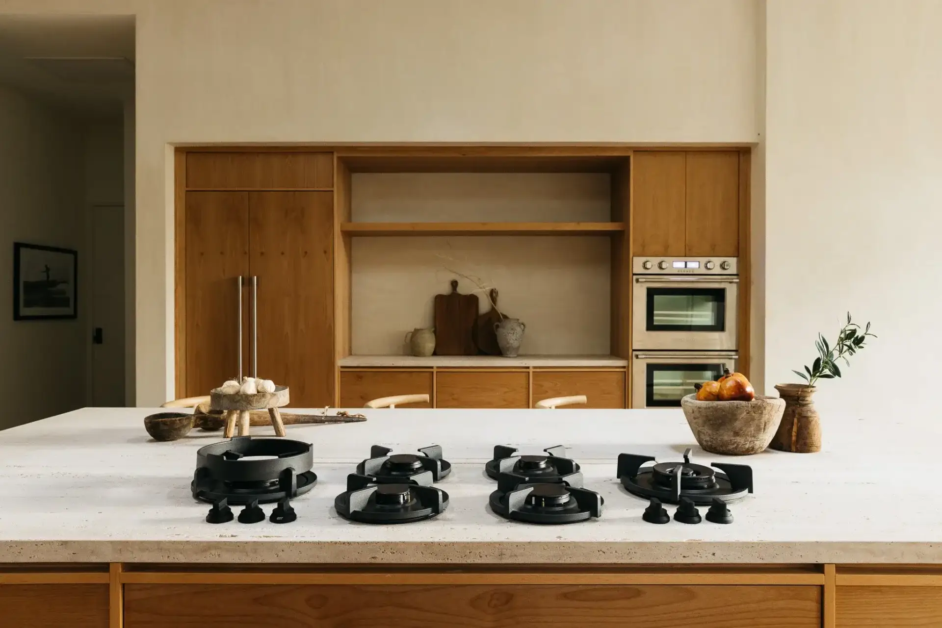 Center elevation of cherry wood kitchens featuring a panel-ready refrigerator wall, open shelves, and double ovens.