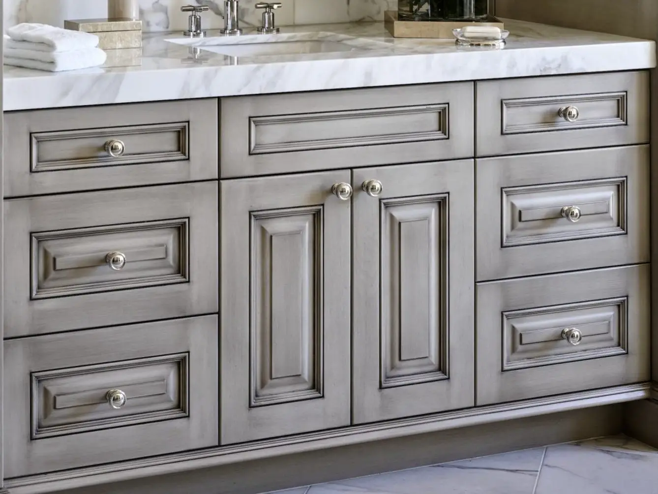 Custom painted and glazed raised panel cabinets with hand-wiped shadow highlights in moldings.