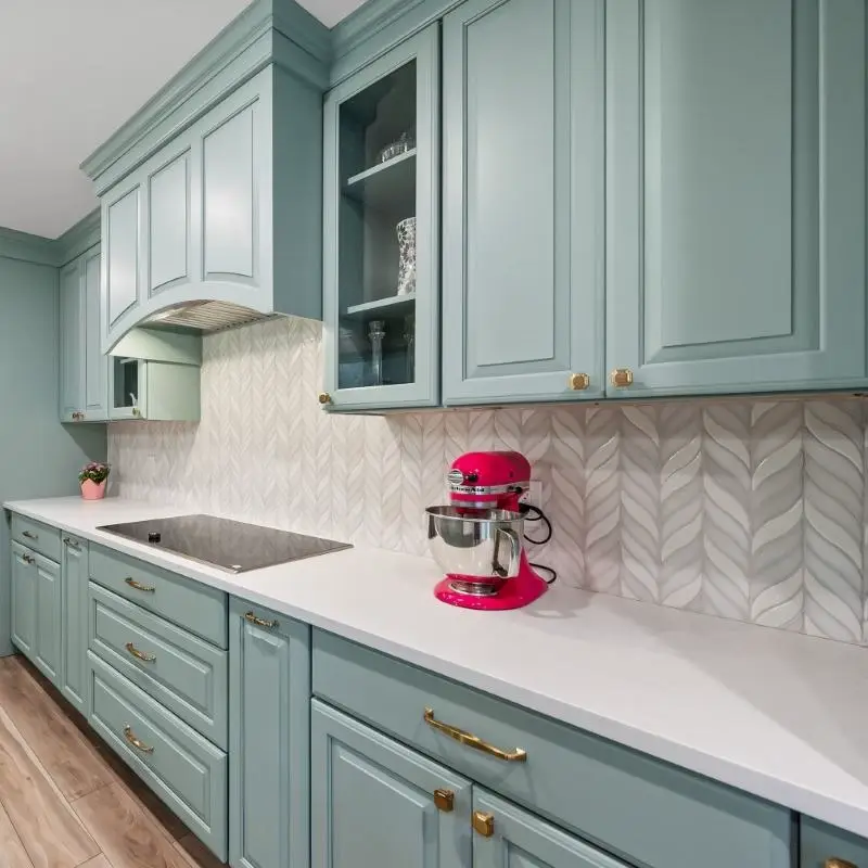 Traditional kitchen featuring raised panel cabinet doors with ogee profile detailing and multi-layered warm cream lacquered finish.