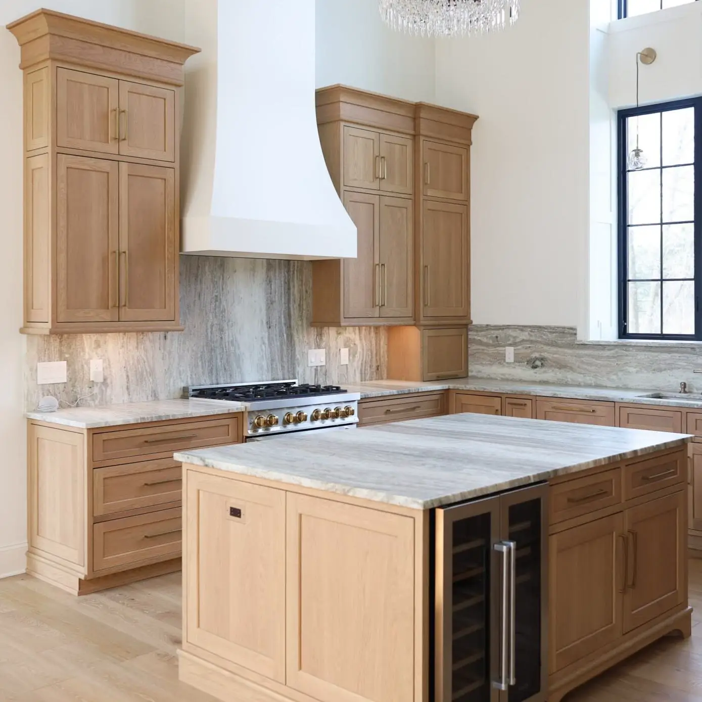 Five-piece shaker cabinet doors with 2.5-inch stiles and rails in a soft warm white painted finish with brushed brass hardware.