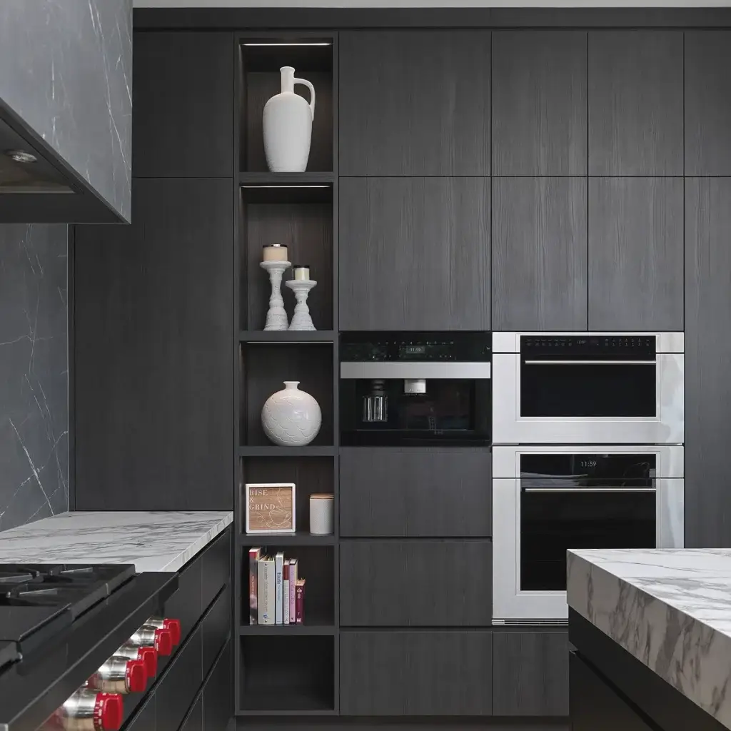 Modern kitchen featuring seamless slab cabinet doors and flat panel cabinet doors in grain-matched rift white oak with black Gola handleless profiles.