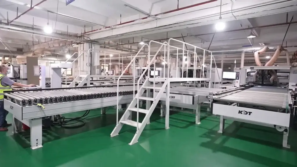 Industrial KDT CNC nesting center and heavy-duty automated conveyance machinery at ALLAND Custom Cabinetry factory