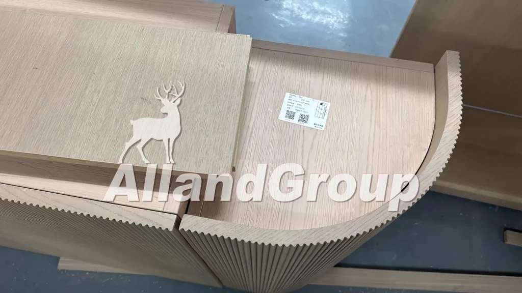 Close-up detail of curved fluted oak veneer cabinet corner with factory barcode tracking label
