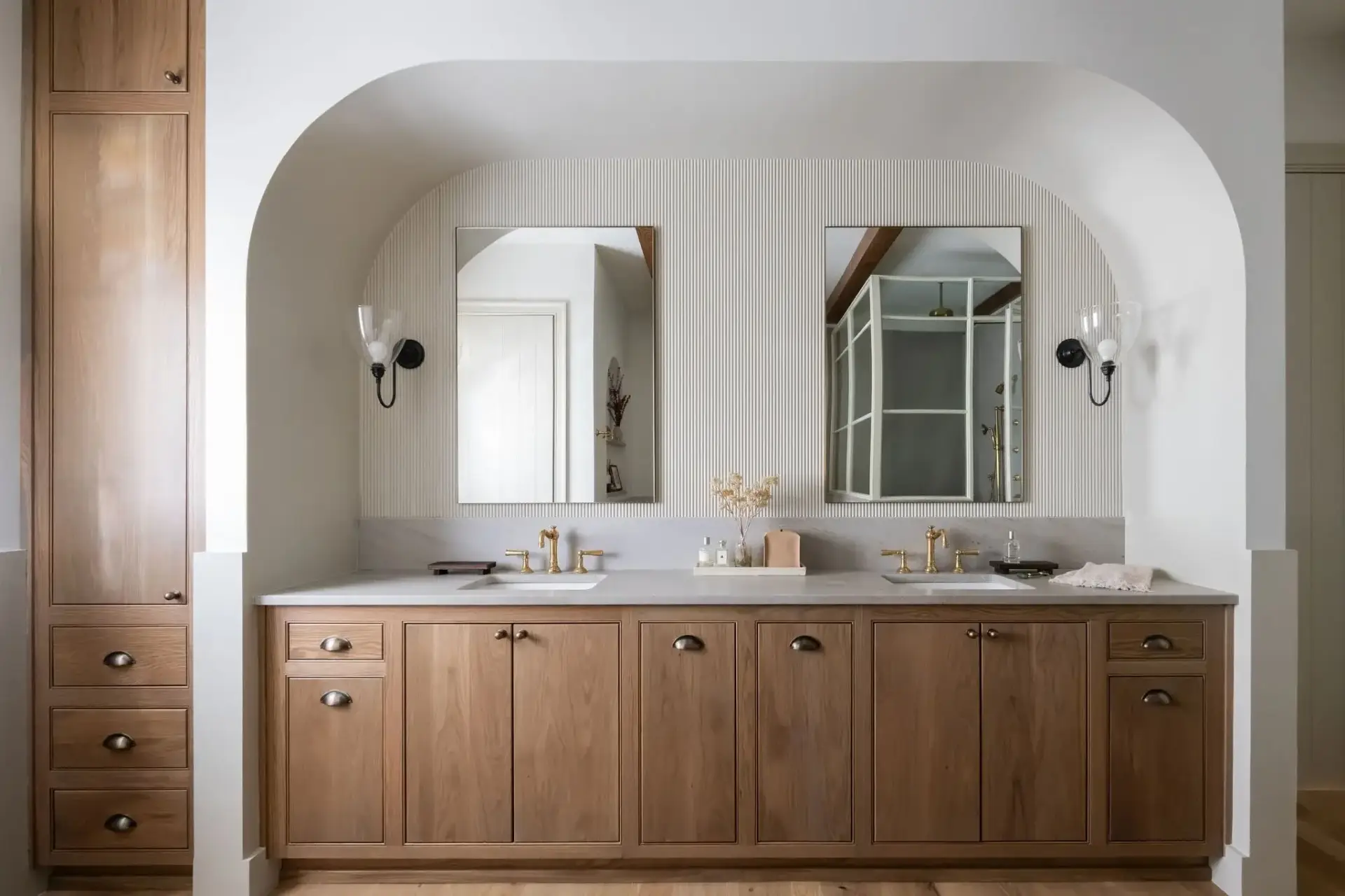 Custom white oak bathroom vanity with double sink undermount basins in alcove