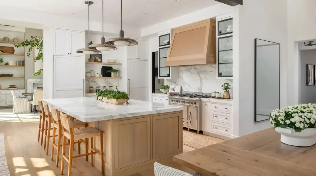 Symmetrical center perspective of a kitchen with white cabinets and white countertops showing white oak inset island.