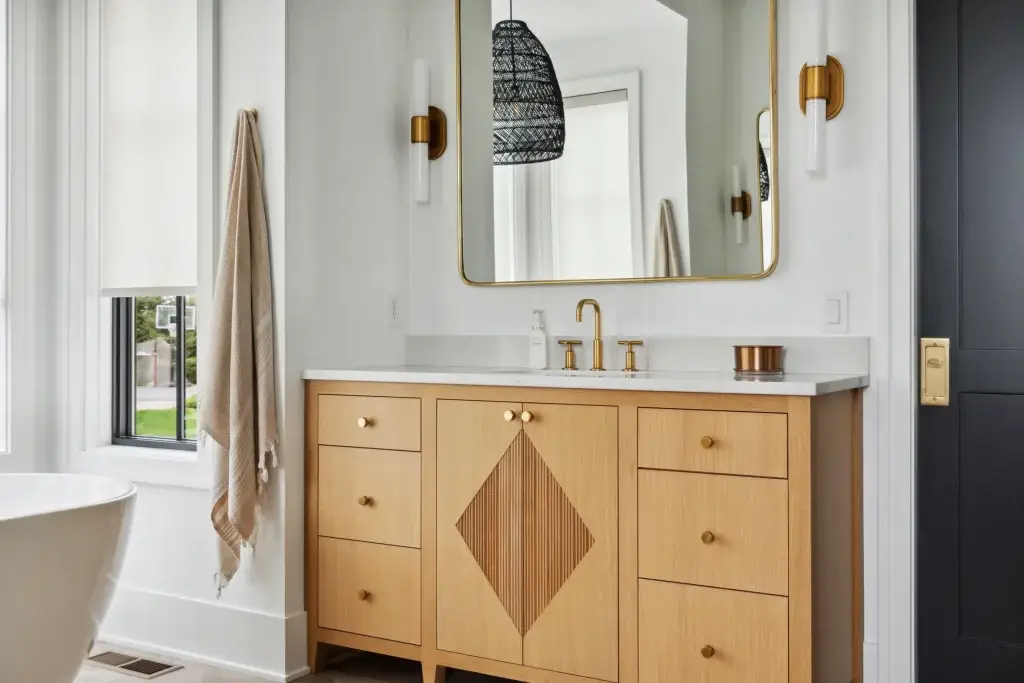 Light oak bathroom cabinets with flush drawer reveals and factory-machined stone top clearances