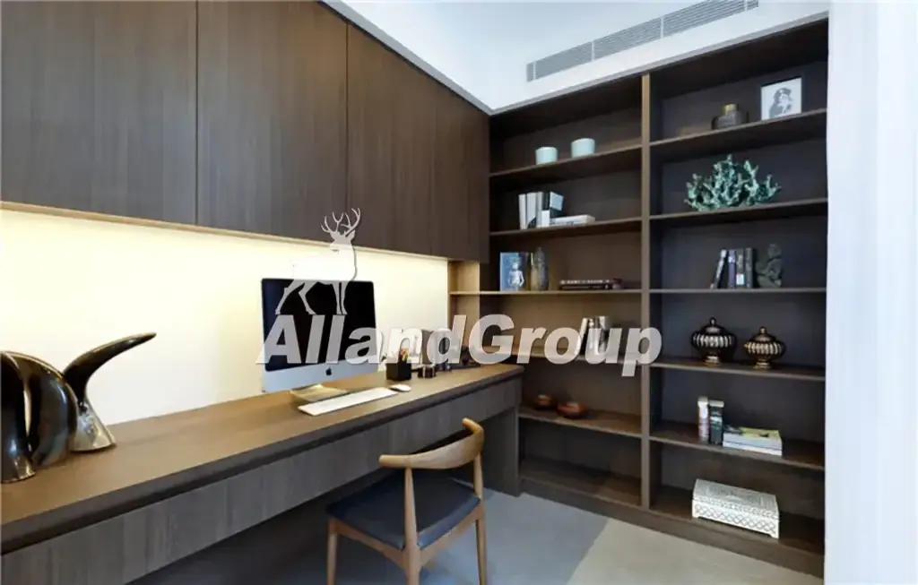 Built-in modern wood veneer desk and floor-to-ceiling bookshelf in private study