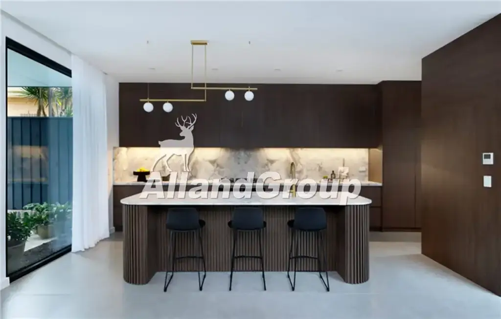 Completed modern wood veneer kitchen cabinet with fluted curved island and pendant lights