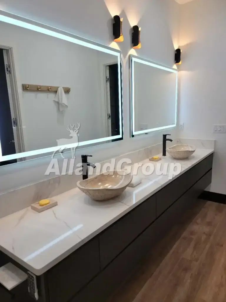 Modern floating double bathroom vanity with stone vessel sinks and backlit mirrors