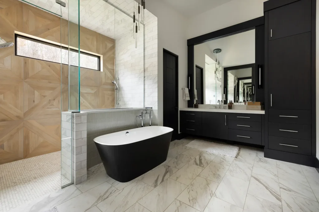Full-height black bathroom storage cabinet linen tower paired with floating vanity