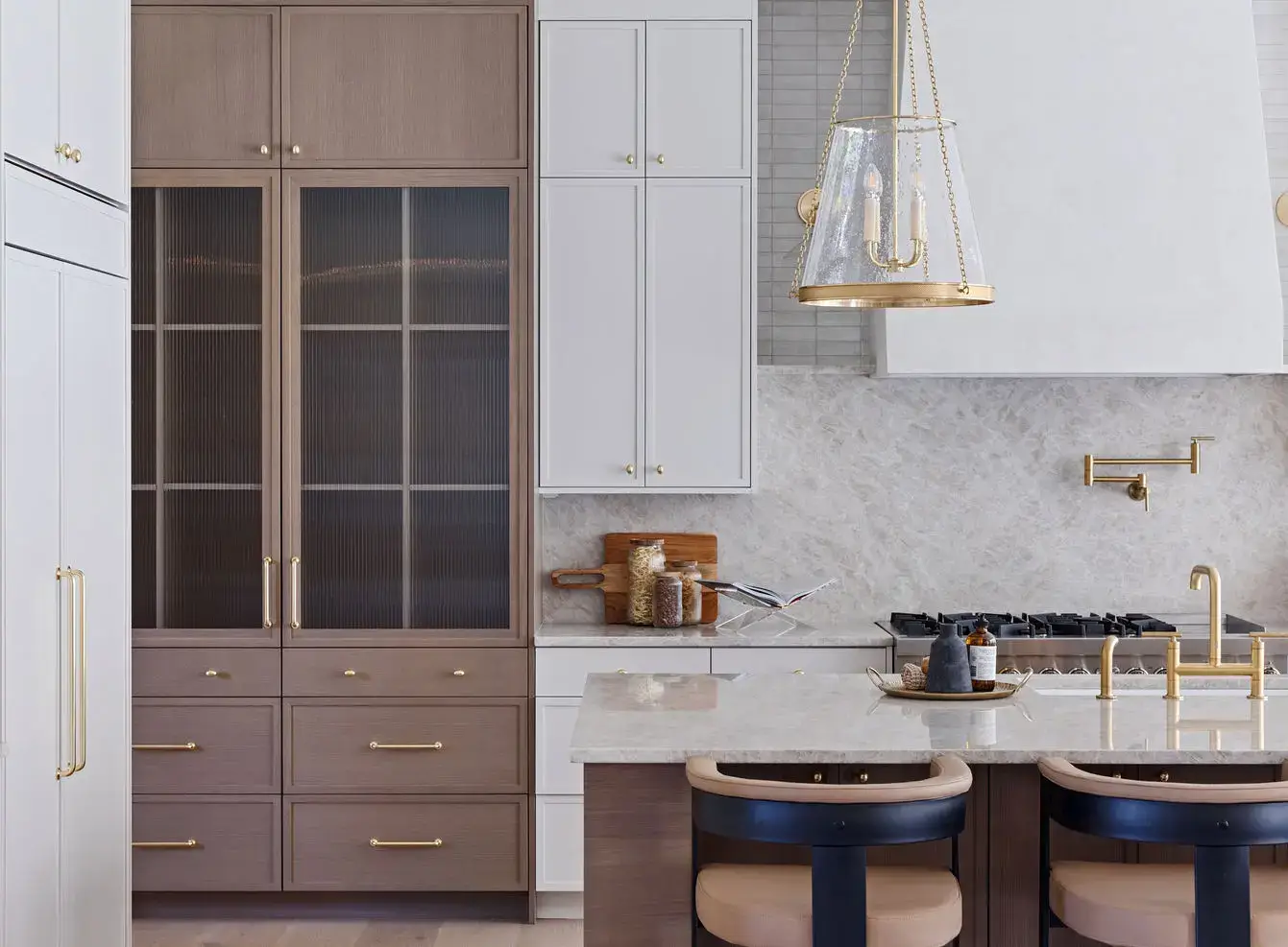 Rift white oak kitchen cabinets pantry tower with fluted glass doors next to white slim shaker cabinets